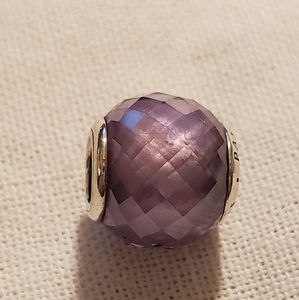 2 Pandora beads one purple and one pink.